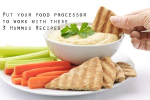 HUmmus in a bowl surrounded by vegetables