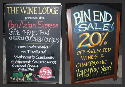 Sidewalk signs with colorful text and images.