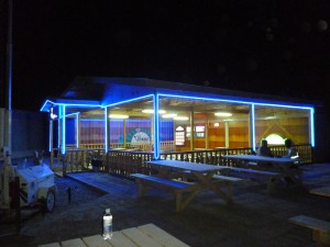 Afghan Village 1 The blue neon light from Afghan Village Cuisine, which was stocked by KaTom Restaurant Supply, spills out onto the desert at Kandahar Airfield.