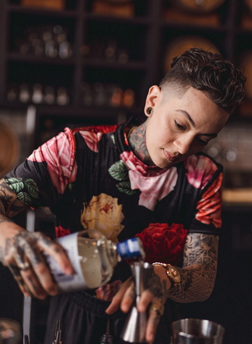 Bad Birdy pours a mixed drink at the bar