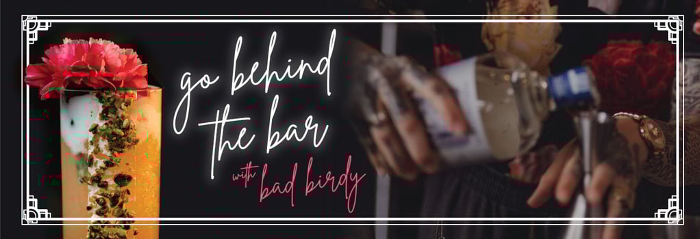 Text reads: Go Behind the Bar with Bad Birdy. Image of mixed drink and bartender.